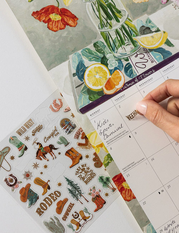 Calendar with decorative stickers on a white surface