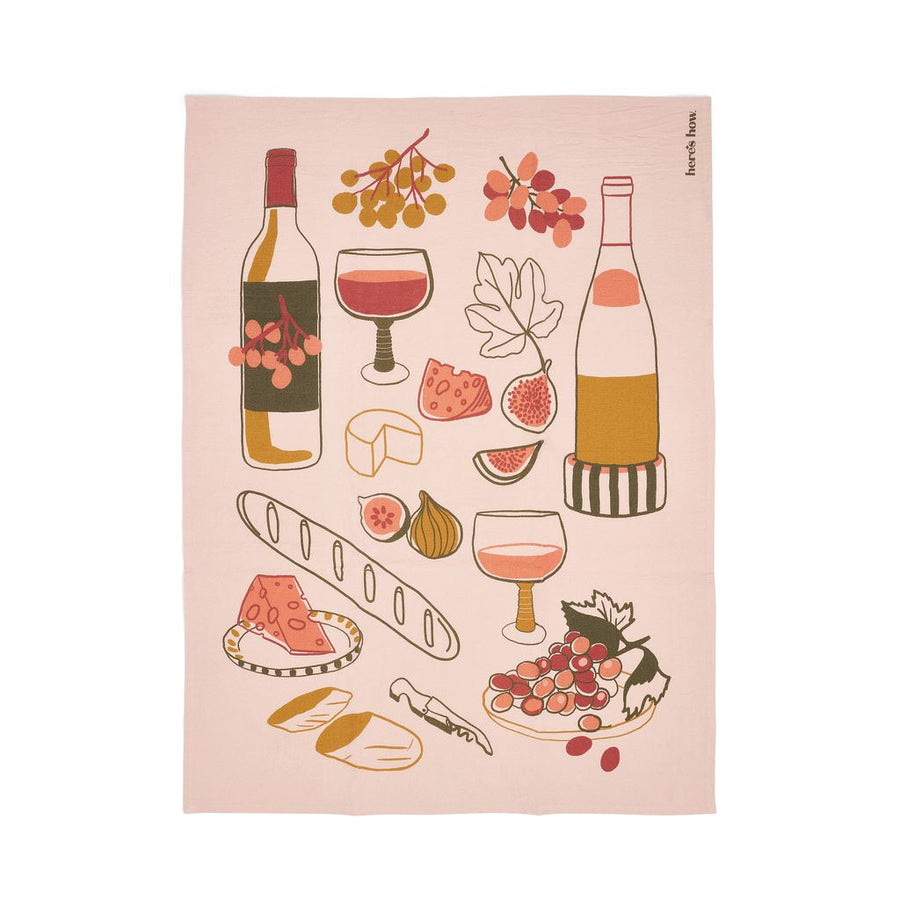 Tea towel with wine-themed illustrations on a pink background