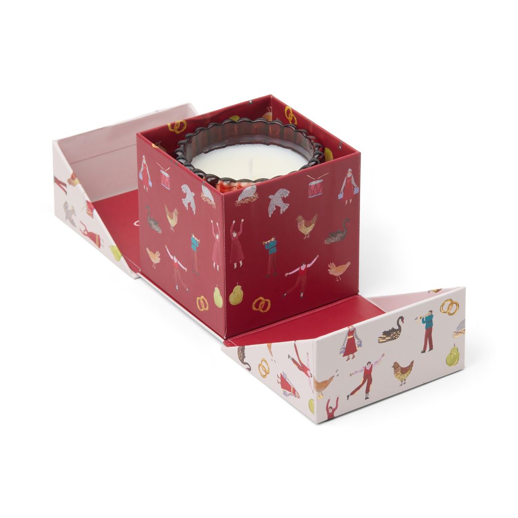 Decorative candle in a patterned box on a white background