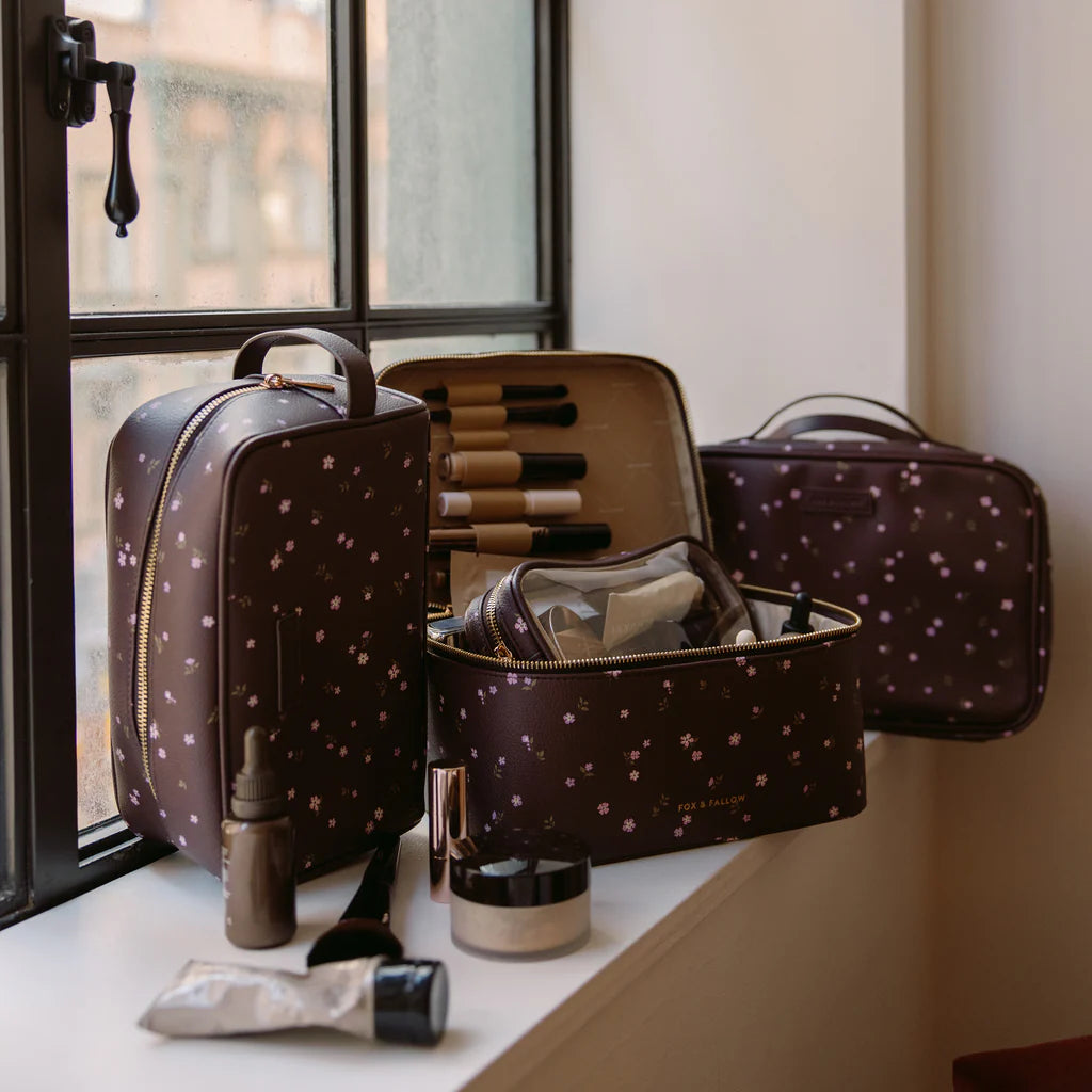 Makeup bag with cosmetic items on a windowsill