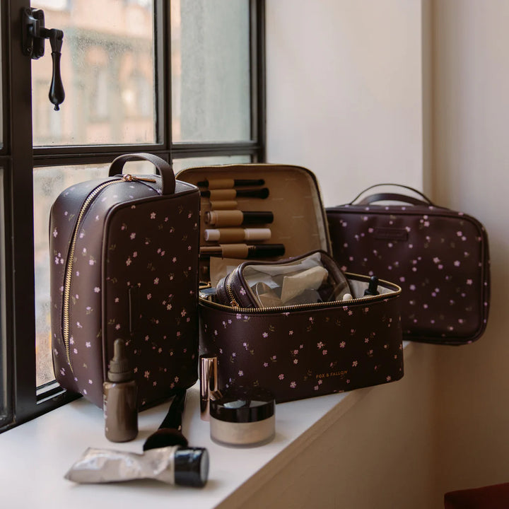 Makeup bag with cosmetic items on a windowsill