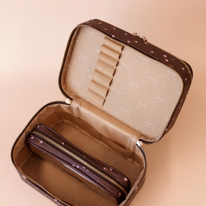 Open vanity case items on a beige background