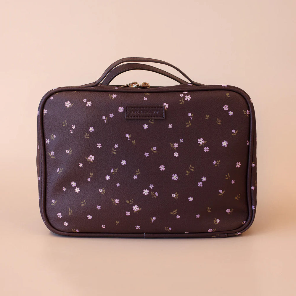 Floral-patterned cosmetic bag on a beige background