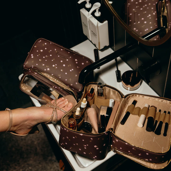 Makeup bags with various items on a vanity table