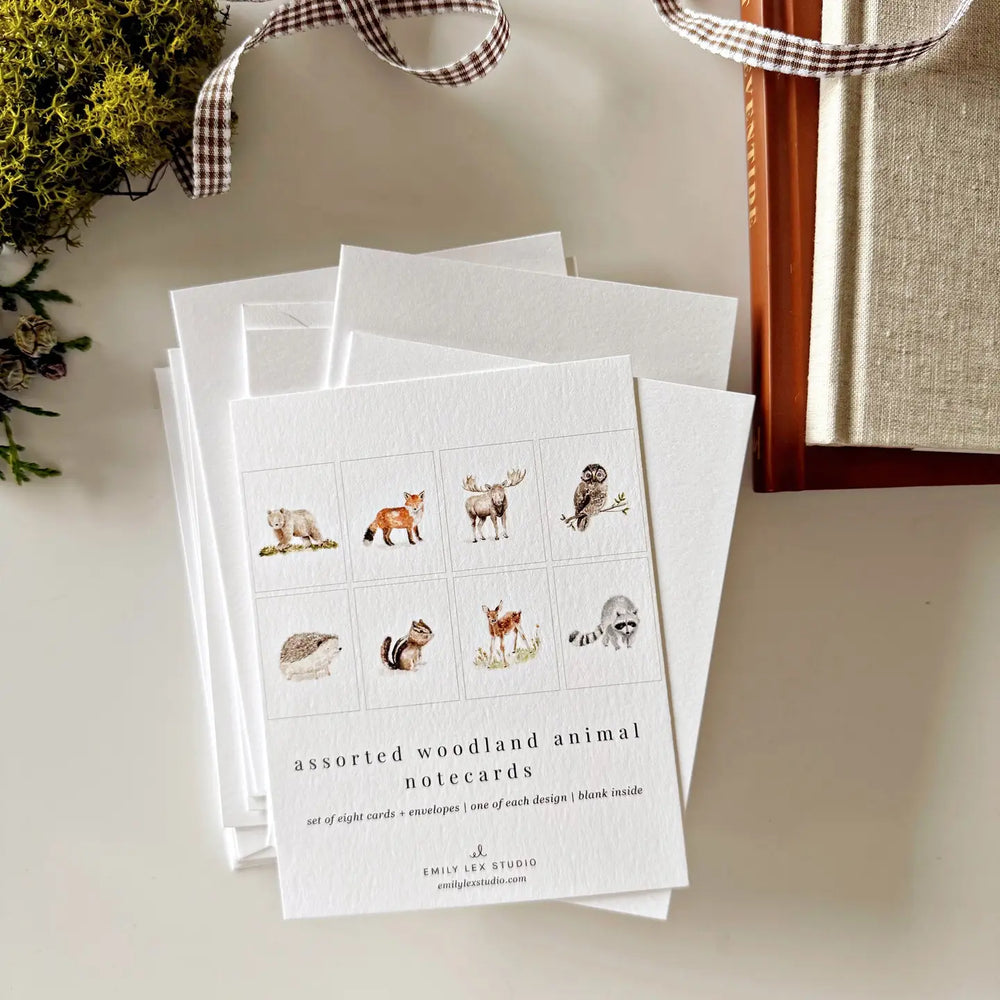 Set of woodland animal notecards with a checkered ribbon on a neutral background