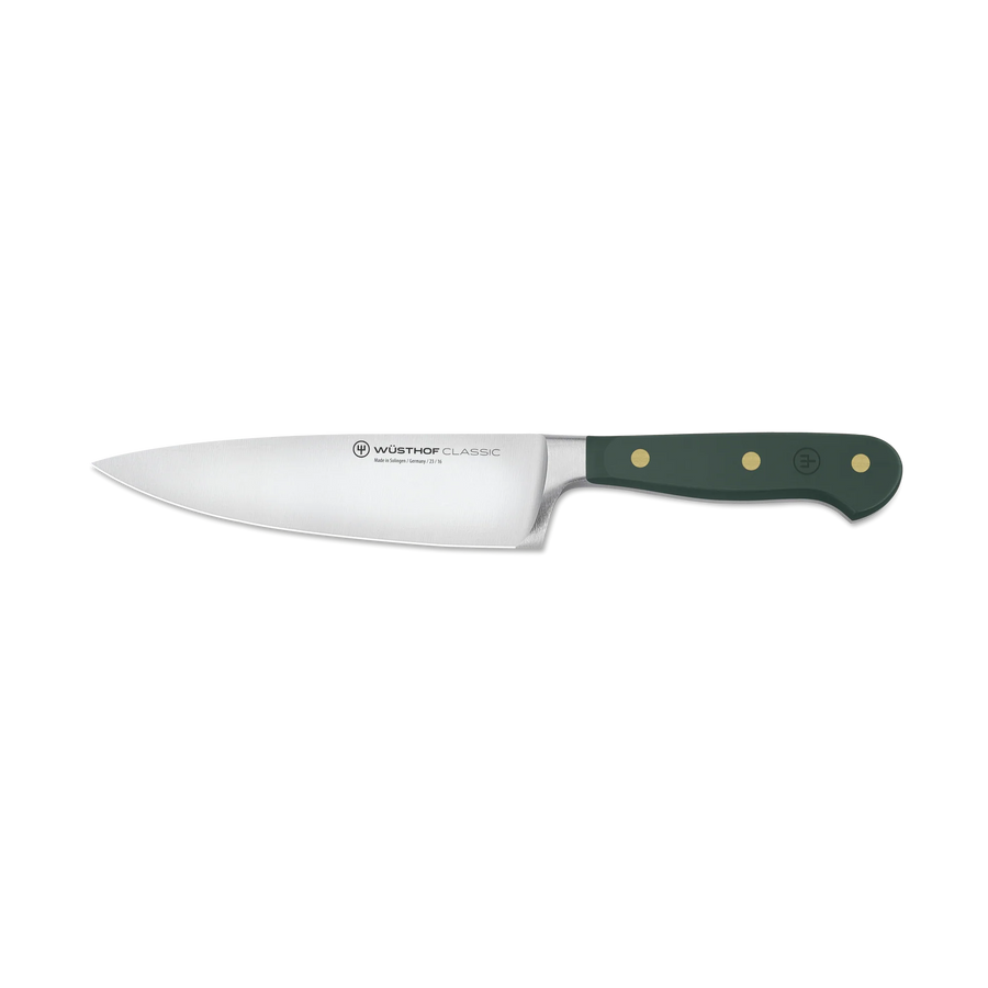 Chef's knife with a green handle on a white background