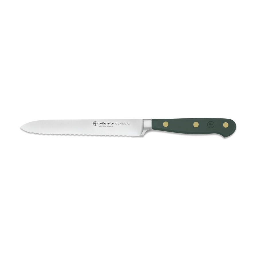 Wusthof serrated knife with green handle on a white background