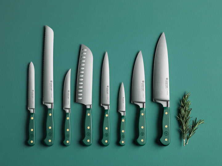 Set of Wusthof  knives with green handles on a teal background