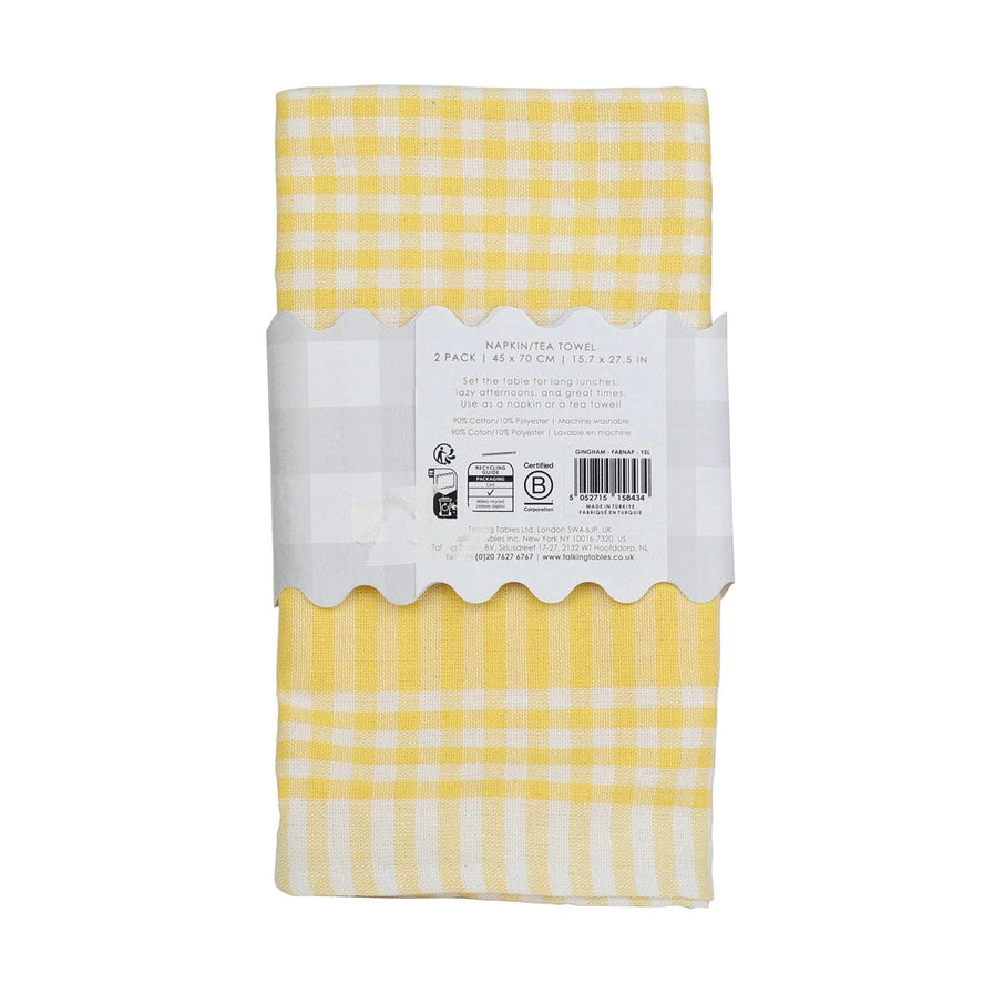 Packaged yellow and white checkered napkins with a label on a white background