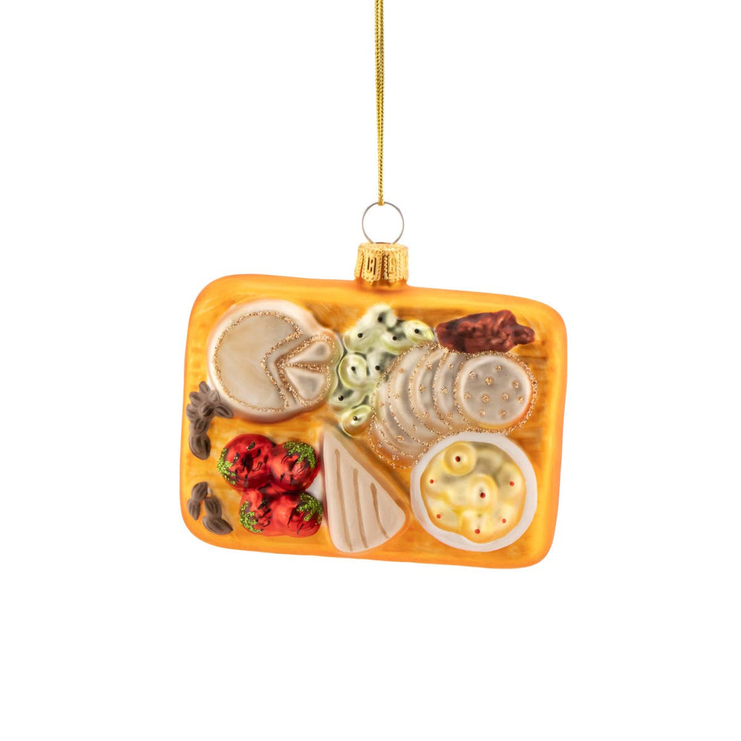 Decorative food platter ornament with various items on a white background