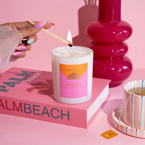 A white candle labeled &