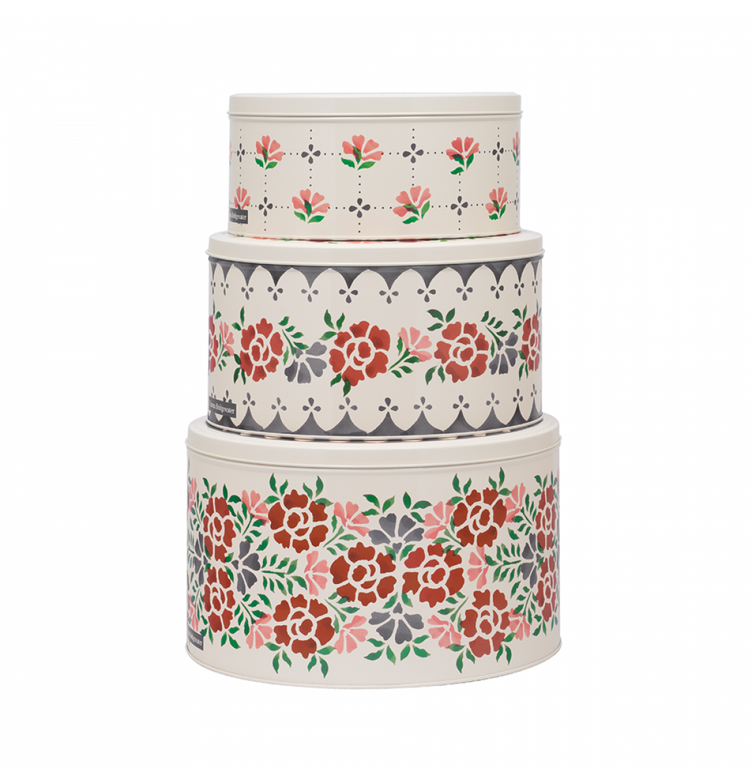 Three nested round storage tins with a vintage floral and geometric pattern on a white background.