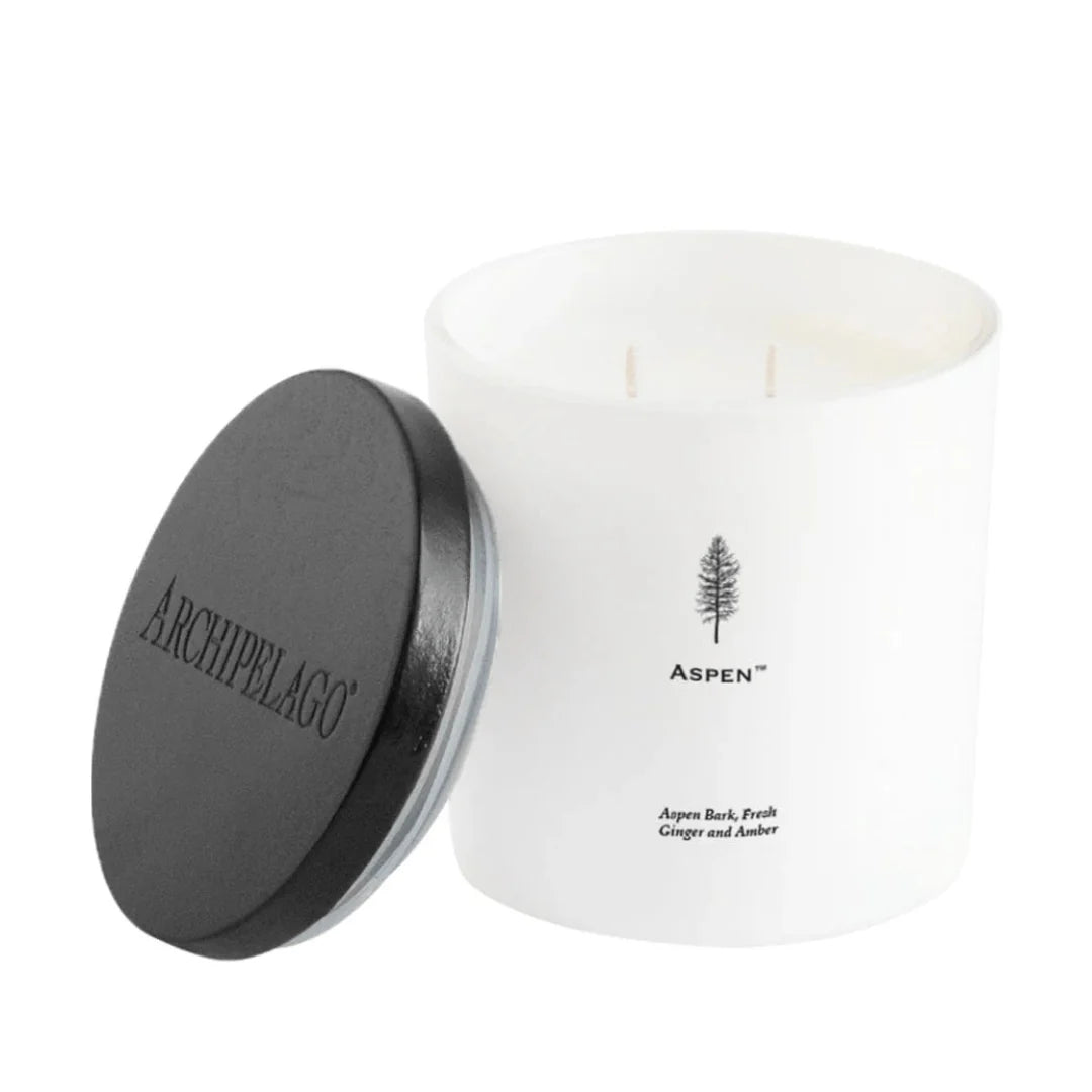 Archipelago candle with a white vessel and black lid on a white background
