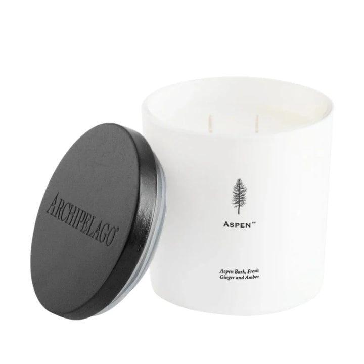 Archipelago candle with a white vessel and black lid on a white background