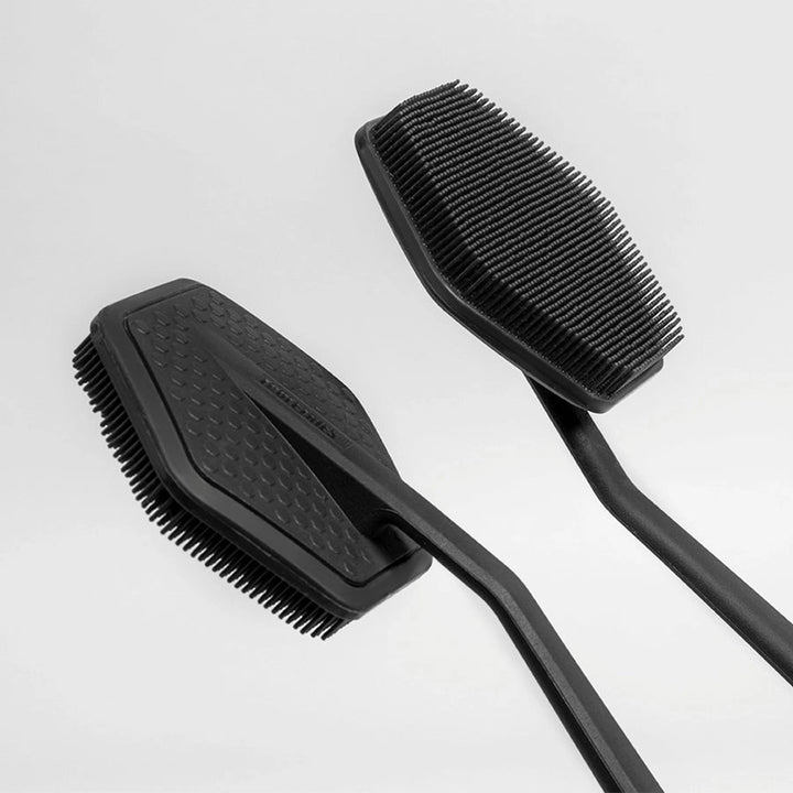 Two silicone back scrubber heads on a white background