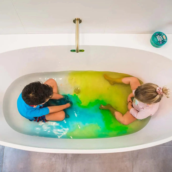 Kids in a bath with coloured bath drops
