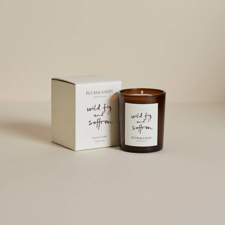 Plum &amp; Ashby candle and packaging on a beige background