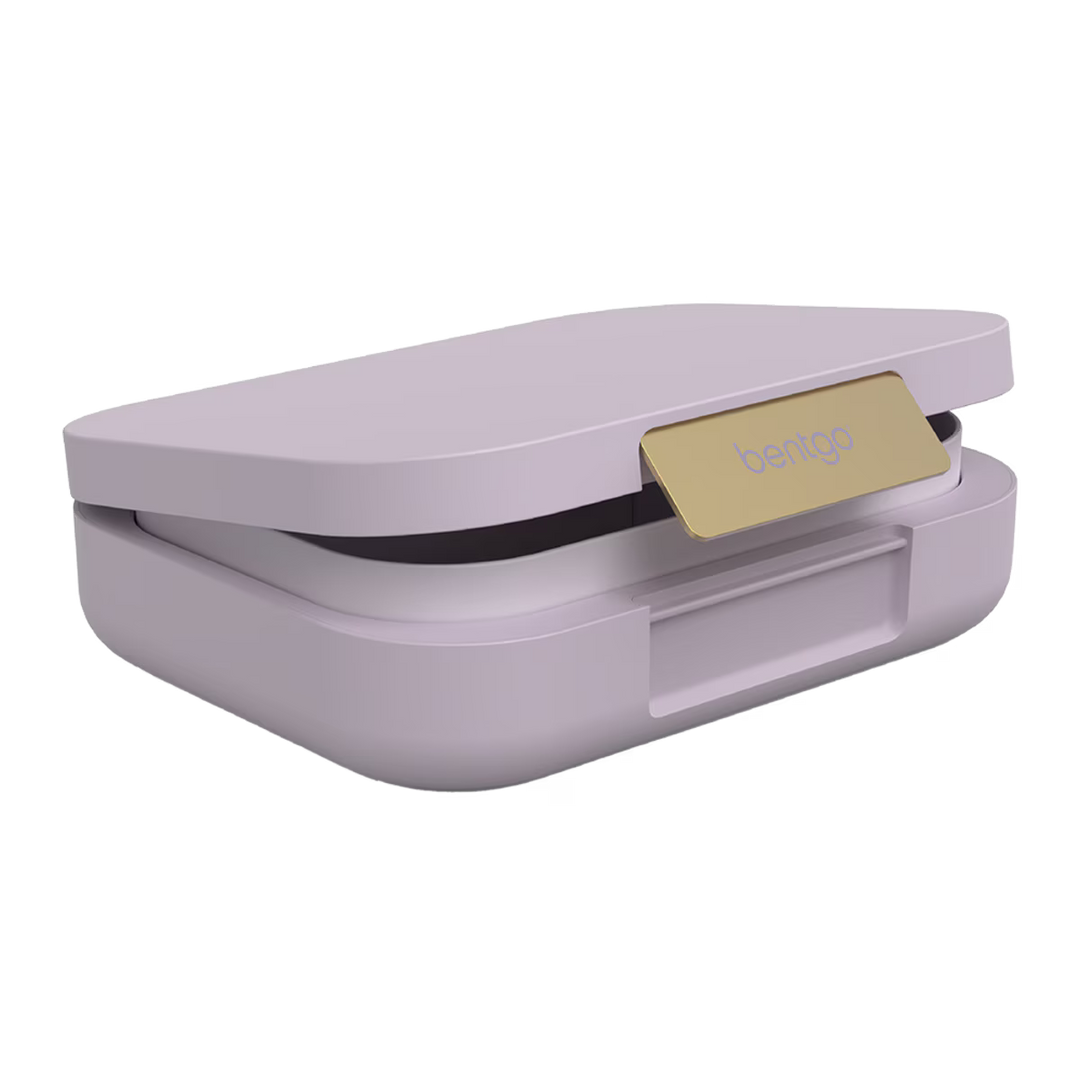 Purple lunch box with a gold tag on a white background