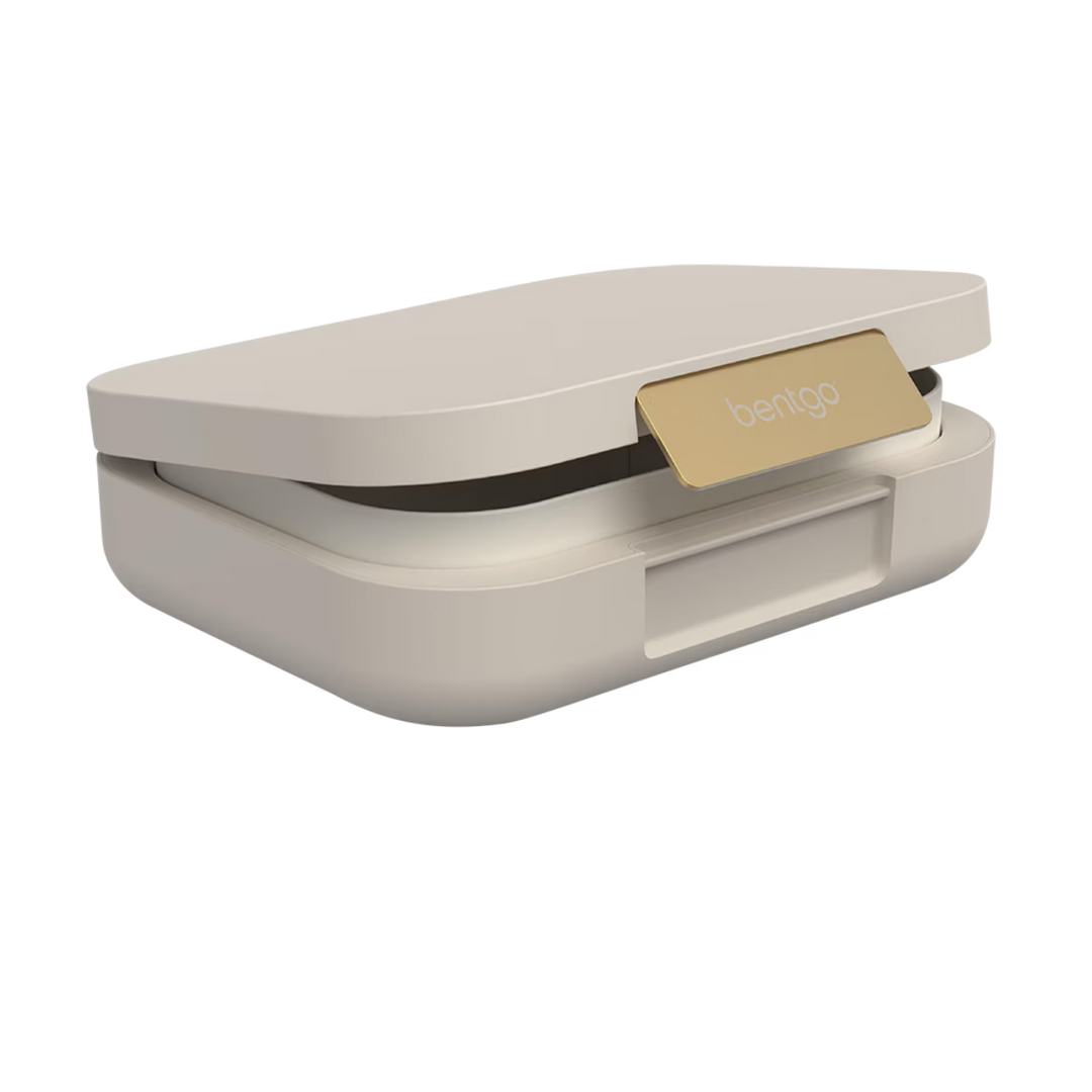 Beige food container with gold lid on a white background