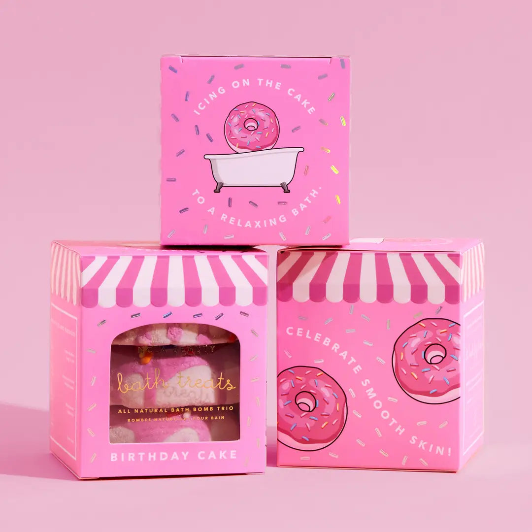 Pink packaging of bath products with donut design on a pink background