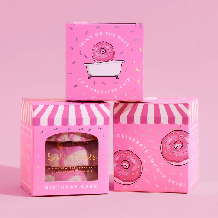 Pink packaging of bath products with donut design on a pink background