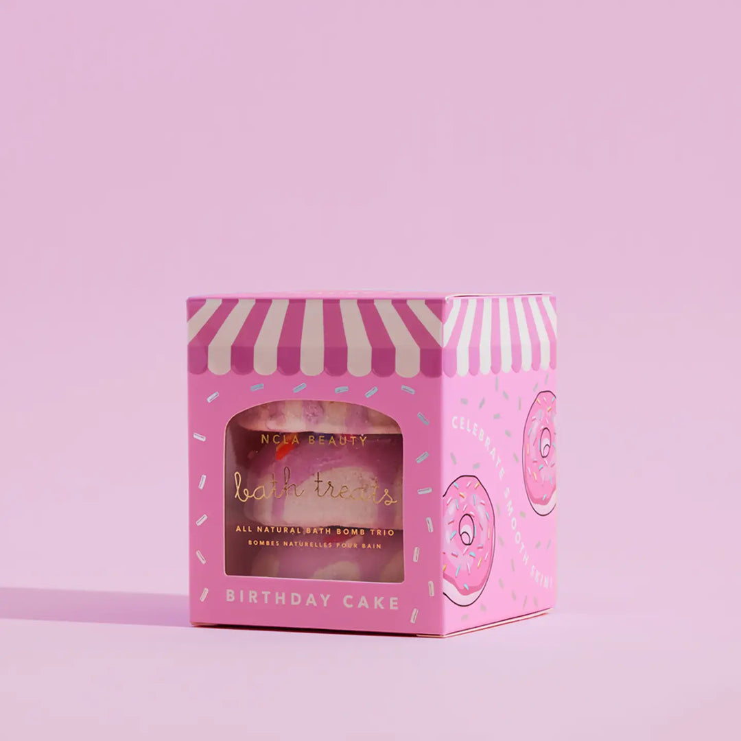 Pink bath bomb trio packaging with striped lid on a pink background