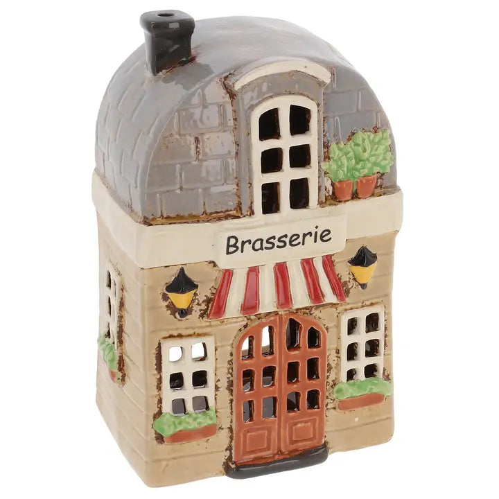 Decorative ceramic tealight holder of a building with 'Brasserie' sign on a white background