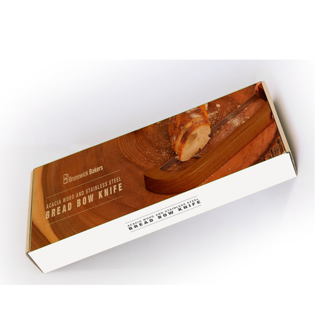 Box for a bread bow knife with a wooden handle and stainless steel blade on a white background.