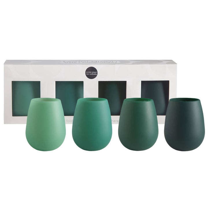 Four stemless wine glasses in a gradient of green shades, displayed in front of their white packaging box on a white background.