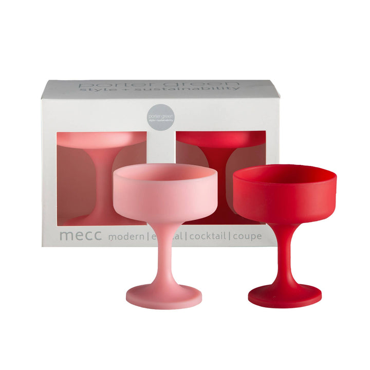 Two red and pink silicone cocktail glasses in front of a MECC branded box on a white background