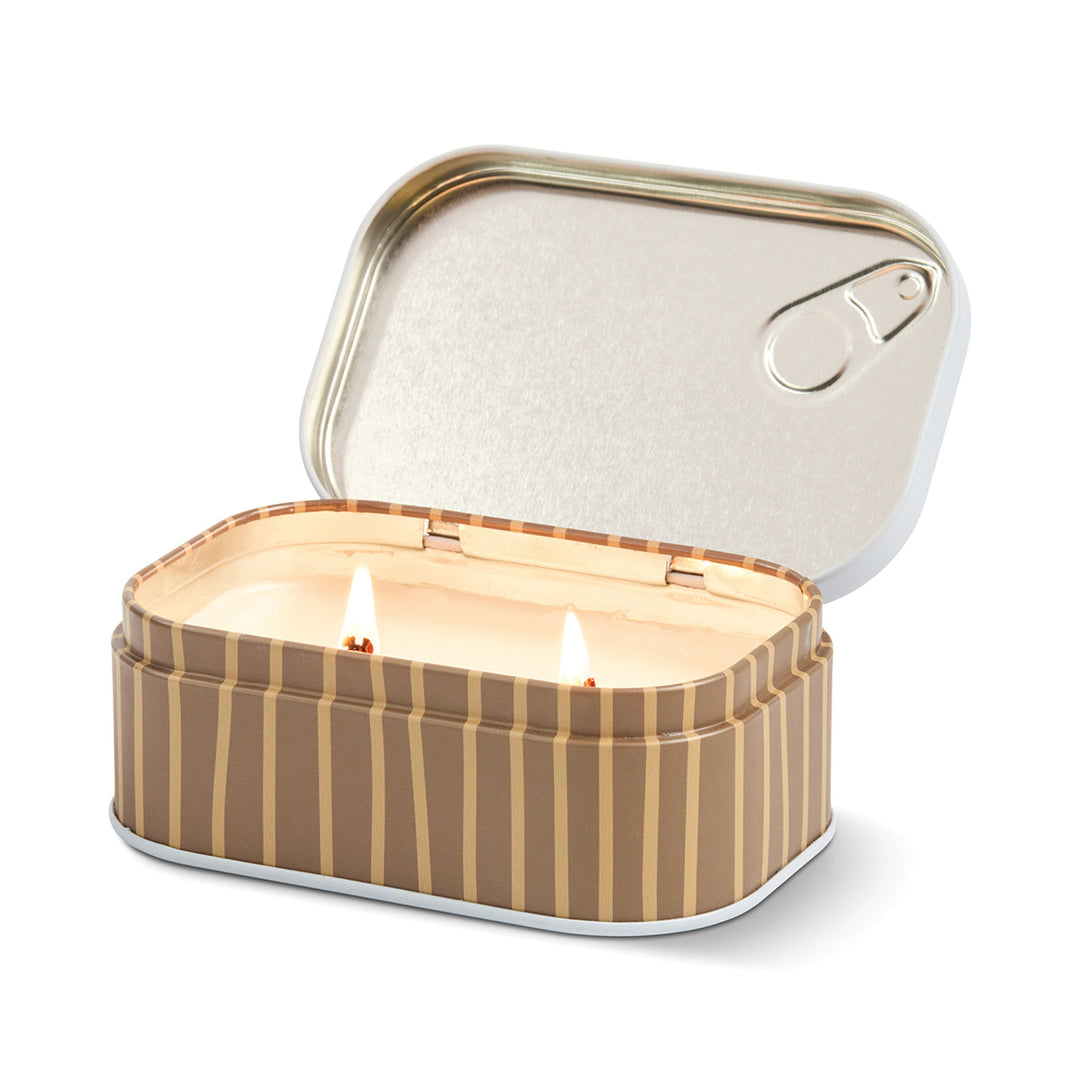Striped candle in a tin with a white background