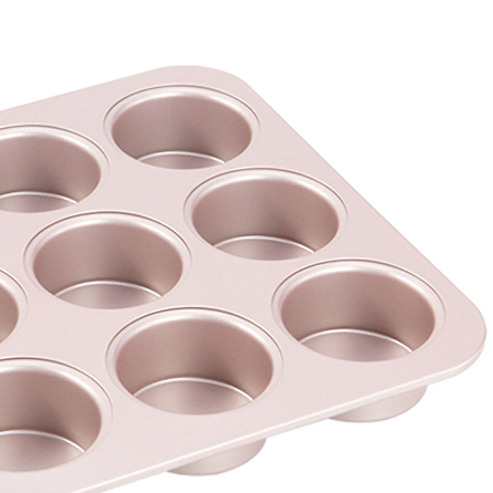 Pink muffin tin with multiple compartments on a white background