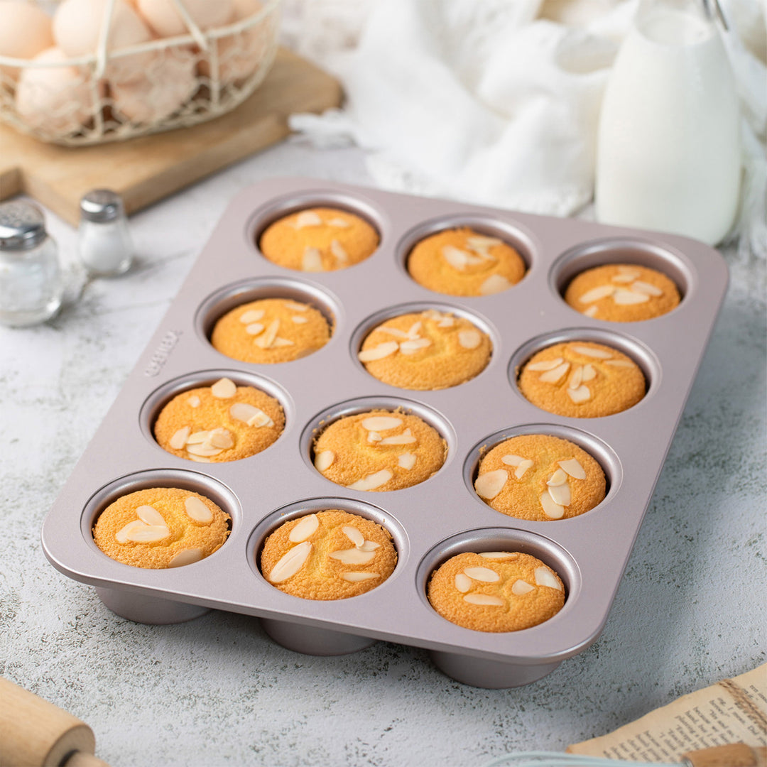 Muffin tray with baked muffins on a kitchen counter