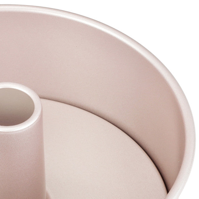 Close-up of a pink angel cake pan on a white background