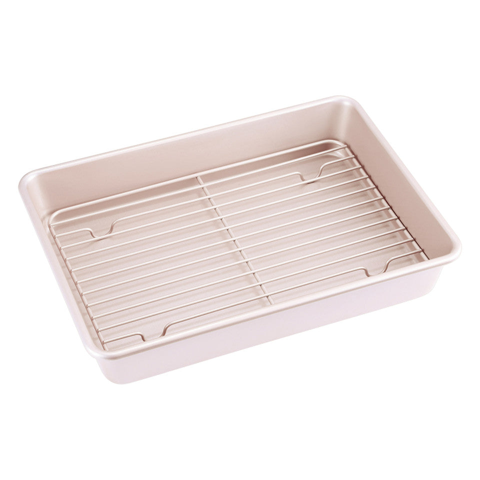 Beige baking pan with wire rack on a white background