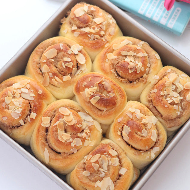 Baked rolls with almonds in a baking tray