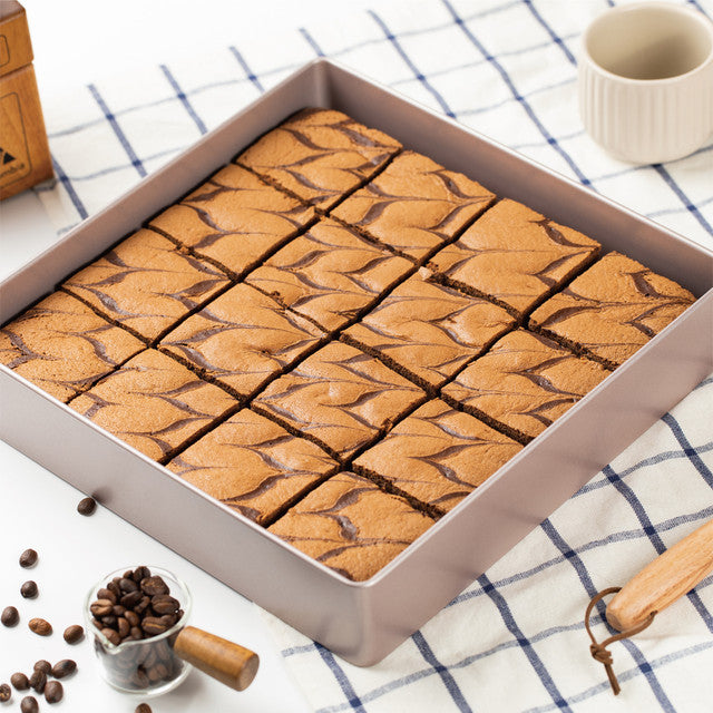 Brownies with a checkered tablecloth and coffee beans in the background