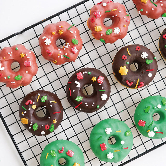 Colorful donuts with sprinkles on a cooling rack