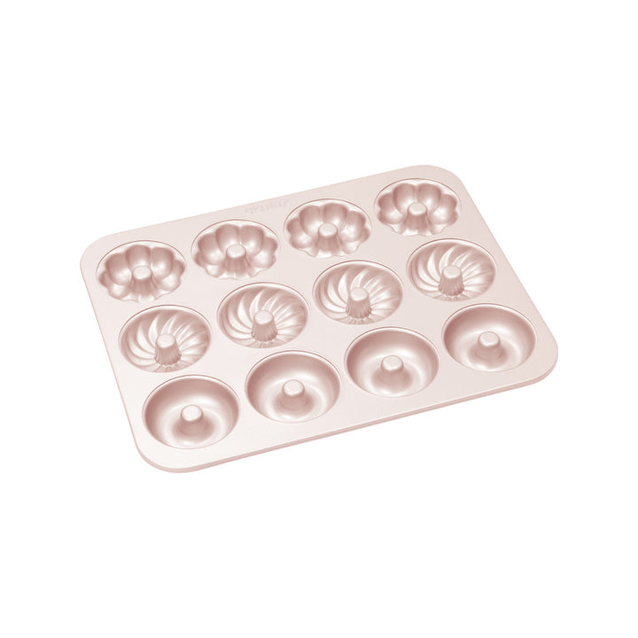 Rose gold donut-shaped baking mold on a white background