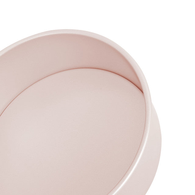 Close-up of a pink cake tin on a white background