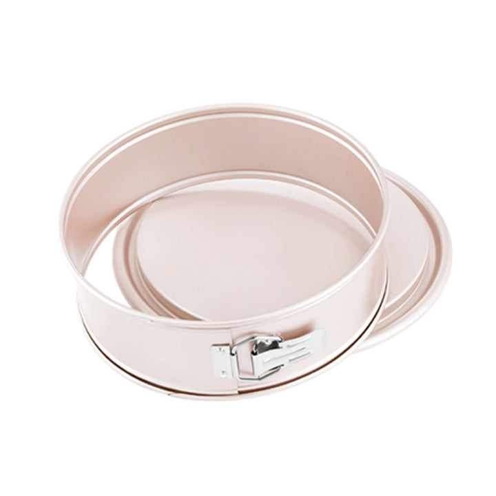 Round metal baking pan with a lid on a white background