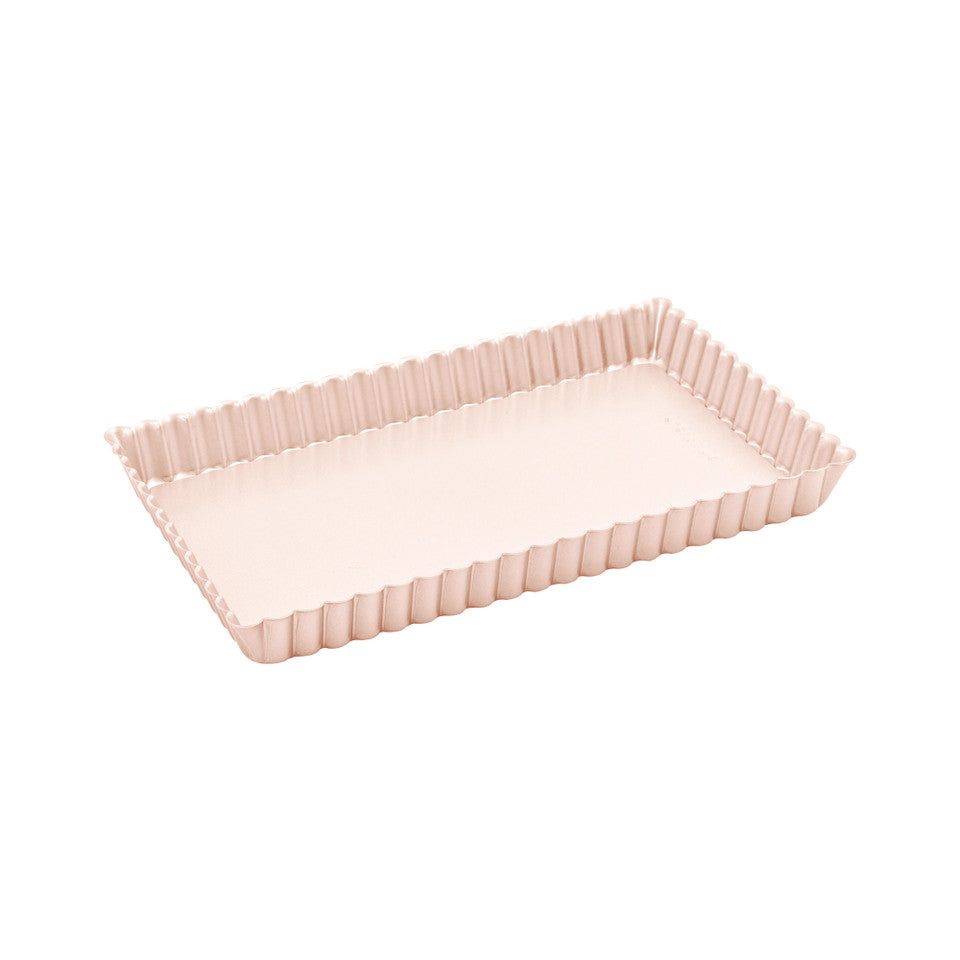 A pink tart tin on a white background