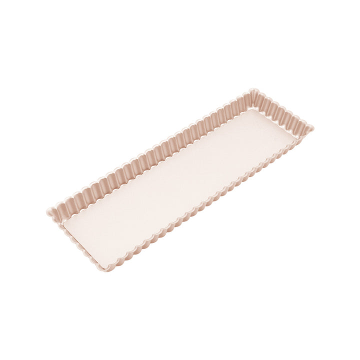 Rectangular tart tin with scalloped edge on a white background