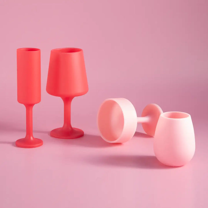 Set of pink silicone cups on a pink background