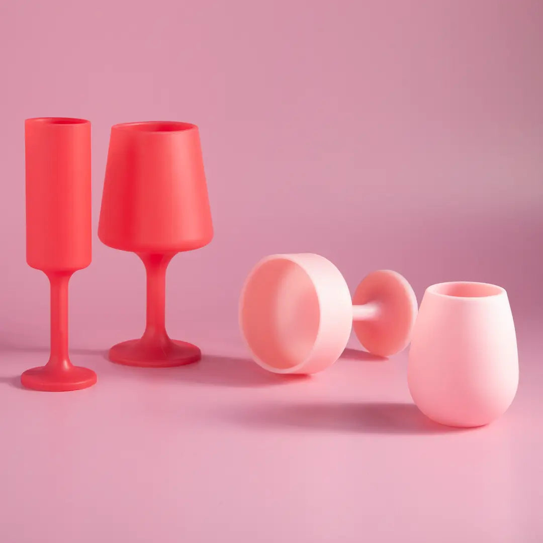 Set of red and pink silicone cups on a pink background