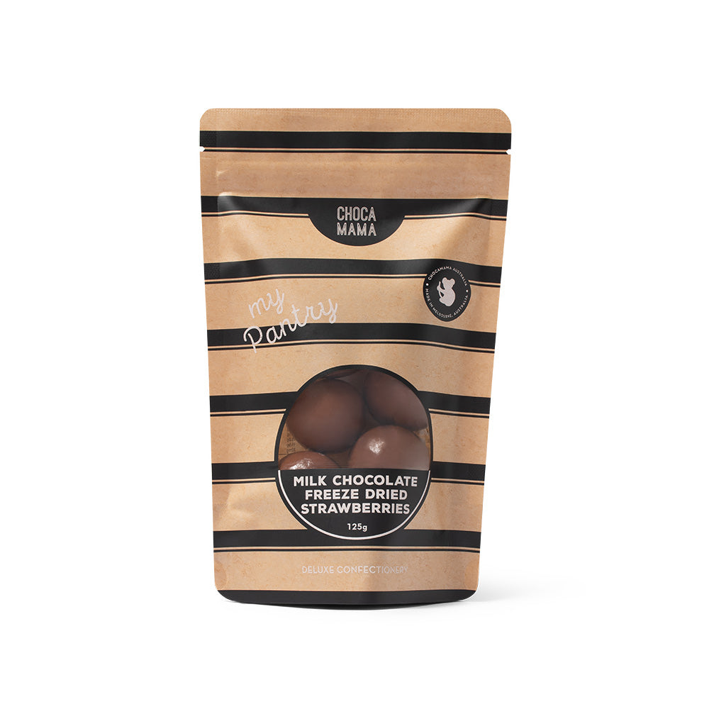 A stand-up pouch of Choca Mama Milk Chocolate Freeze Dried Strawberries, featuring a kraft paper design with black horizontal stripes and a clear window showing the chocolate spheres inside.