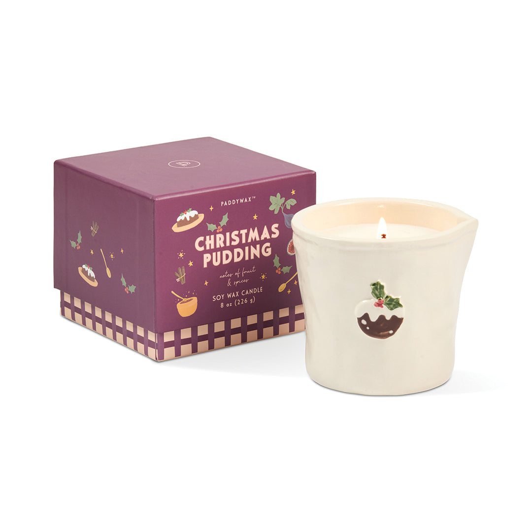 White ceramic candle with Christmas pudding motif with packaging on a white background