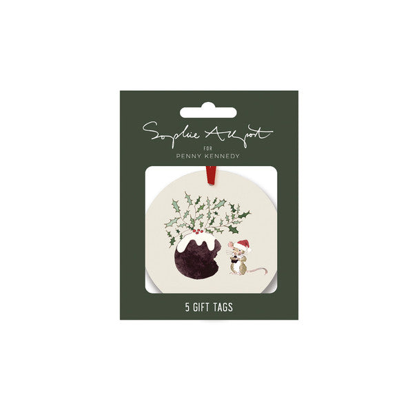 A round Christmas gift tag in its original packaging, featuring a cream-colored tag with a Christmas pudding under green holly leaves, a small white mouse in a Santa hat, and a red hanging ribbon. The packaging card is dark green with white text reading &
