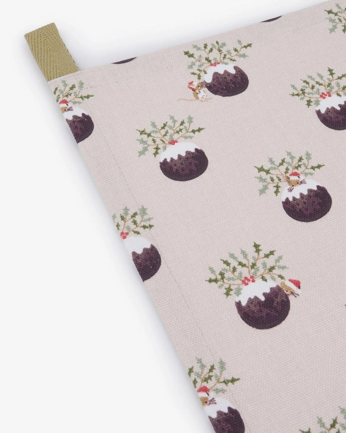 A fabric tea towel featuring a repeating pattern of Christmas puddings