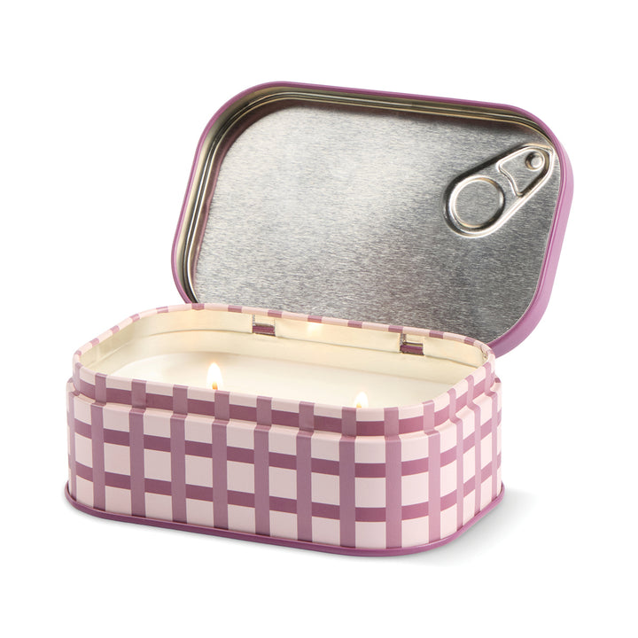 Sardine can-shaped candle with checkered design on a white background